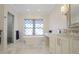 Bright bathroom features soaking tub, marble counters, and glass enclosed shower at 18 Polo Ne Dr, Atlanta, GA 30309