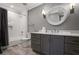 Bathroom with a vanity, large round mirror and tiled shower at 18 Polo Ne Dr, Atlanta, GA 30309