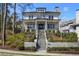 Stunning two-story white brick home with manicured landscaping and inviting staircase at 18 Polo Ne Dr, Atlanta, GA 30309