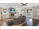 Bright living room features a stone fireplace, a ceiling fan and glass doors at 18 Polo Ne Dr, Atlanta, GA 30309