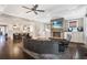 Inviting living room with a stone fireplace, built-in cabinets, hardwood floors, and access to the kitchen at 18 Polo Ne Dr, Atlanta, GA 30309