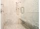 Close up of beautiful shower with marble tile, seat and glass door at 18 Polo Ne Dr, Atlanta, GA 30309