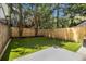 Fenced backyard featuring a green lawn and stone patio area with partial shade at 657 Stratford Green Way, Avondale Estates, GA 30002