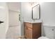 Well-lit bathroom with modern vanity and fixtures, with view into adjacent room at 657 Stratford Green Way, Avondale Estates, GA 30002