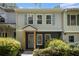 Charming townhome featuring light siding, blue shutters, a covered entryway, and well-maintained landscaping at 657 Stratford Green Way, Avondale Estates, GA 30002