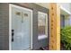 Close-up of painted front door with glass features and view of adjacent window at 657 Stratford Green Way, Avondale Estates, GA 30002