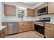 Renovated kitchen with stainless steel appliances, white countertops, and light brown cabinets at 657 Stratford Green Way, Avondale Estates, GA 30002