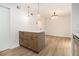 Eat in kitchen featuring a center island with pendant lights, light countertops, and wood look flooring at 657 Stratford Green Way, Avondale Estates, GA 30002