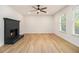 Living room with brick fireplace, luxury vinyl plank flooring, and large windows at 657 Stratford Green Way, Avondale Estates, GA 30002