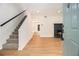 Bright living room featuring wood floors, a fireplace, and a staircase leading to the upper level at 657 Stratford Green Way, Avondale Estates, GA 30002