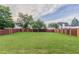 Well-maintained backyard with lush green grass and a wooden privacy fence, perfect for outdoor enjoyment at 806 Chelsea Wood Ct, Stockbridge, GA 30281