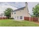 Large backyard with green grass, patio and tall mature trees surrounding the property at 806 Chelsea Wood Ct, Stockbridge, GA 30281