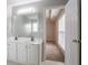 Bathroom featuring a double sink vanity and a view into the carpeted bedroom, seamlessly connecting spaces at 806 Chelsea Wood Ct, Stockbridge, GA 30281
