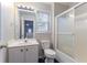 Cozy bathroom with shower, toilet, vanity, and mirror, with a window for natural light at 806 Chelsea Wood Ct, Stockbridge, GA 30281