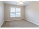 Neutral bedroom featuring a carpeted floor, window with blinds, and ample natural light at 806 Chelsea Wood Ct, Stockbridge, GA 30281