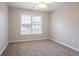 Bright bedroom featuring a carpeted floor, window with blinds, and neutral walls at 806 Chelsea Wood Ct, Stockbridge, GA 30281