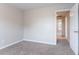 Neutral bedroom featuring carpet floors and a door leading to the hallway at 806 Chelsea Wood Ct, Stockbridge, GA 30281