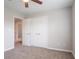 Bedroom featuring neutral walls, carpeted floor, and a double door closet for a comfortable living space at 806 Chelsea Wood Ct, Stockbridge, GA 30281