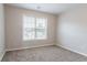 Bright bedroom featuring a carpeted floor, window with blinds, and ample natural light at 806 Chelsea Wood Ct, Stockbridge, GA 30281