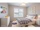 Comfortable staged bedroom with a cozy bed, soft decor and furniture, and natural light from the window at 806 Chelsea Wood Ct, Stockbridge, GA 30281