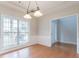 Dining area with hardwood floors and a large window providing ample natural light at 806 Chelsea Wood Ct, Stockbridge, GA 30281