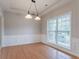 Bright dining area featuring hardwood floors, wainscoting and a stylish two-light chandelier at 806 Chelsea Wood Ct, Stockbridge, GA 30281