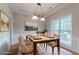 Staged dining room with hardwood floors, neutral walls, and natural light from large window at 806 Chelsea Wood Ct, Stockbridge, GA 30281