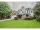 Traditional two-story home with brick and siding exterior, manicured lawn, and inviting front porch at 806 Chelsea Wood Ct, Stockbridge, GA 30281