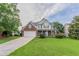 Charming two-story home with a brick facade, white siding, and a well-manicured lawn at 806 Chelsea Wood Ct, Stockbridge, GA 30281