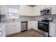 Bright kitchen with stainless steel appliances, light countertops, and hardwood floors, creating an inviting cooking space at 806 Chelsea Wood Ct, Stockbridge, GA 30281