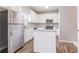 Modern kitchen with white cabinets, stainless steel appliances, and a functional island, designed for culinary enthusiasts at 806 Chelsea Wood Ct, Stockbridge, GA 30281