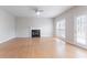 A well-lit living room with light hardwood flooring and a classic fireplace, offering a spacious and inviting atmosphere at 806 Chelsea Wood Ct, Stockbridge, GA 30281