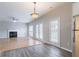 Bright living area with hardwood floors, fireplace, and multiple doors leading to the backyard, blending living spaces at 806 Chelsea Wood Ct, Stockbridge, GA 30281