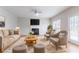 Bright living room featuring a fireplace, ceiling fan, and a comfortable seating arrangement, perfect for relaxation at 806 Chelsea Wood Ct, Stockbridge, GA 30281