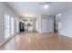 Open-concept living space with hardwood floors, leading to the kitchen, offering an easy flow for modern living at 806 Chelsea Wood Ct, Stockbridge, GA 30281