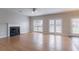 Spacious living area with hardwood floors, fireplace, and doors leading to the backyard, ideal for indoor-outdoor living at 806 Chelsea Wood Ct, Stockbridge, GA 30281