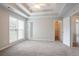 Spacious main bedroom with a tray ceiling, ceiling fan, and large window at 806 Chelsea Wood Ct, Stockbridge, GA 30281
