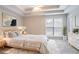 Tranquil main bedroom with tray ceiling, neutral colors, and cozy rug at 806 Chelsea Wood Ct, Stockbridge, GA 30281