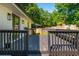 View of a spacious back deck with a white brick house and a leafy green background at 941 Shirley Se St, Smyrna, GA 30082