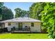 Charming white brick home showcasing a lovely backyard, deck, and verdant lawn at 941 Shirley Se St, Smyrna, GA 30082