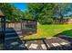 Backyard featuring a wood deck, stone pavers, mature trees and lush green grass at 941 Shirley Se St, Smyrna, GA 30082