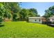 Lush green backyard with detached garage and a wooden fence around the property at 941 Shirley Se St, Smyrna, GA 30082