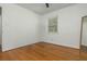 This airy bedroom has hardwood floors, a ceiling fan, and a window for natural light at 941 Shirley Se St, Smyrna, GA 30082