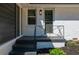 The entryway features a storm door, painted steps and brickwork and manicured landscaping at 941 Shirley Se St, Smyrna, GA 30082