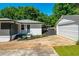 Beautiful exterior features a detached garage, white painted brick, and manicured landscaping at 941 Shirley Se St, Smyrna, GA 30082