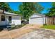 Charming home boasts white painted brick, black trim, lush landscaping and a detached garage at 941 Shirley Se St, Smyrna, GA 30082