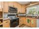 Well-appointed kitchen with stainless steel appliances, light wood cabinets, and charming decor at 941 Shirley Se St, Smyrna, GA 30082
