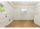 Bright laundry room with white walls, tile floors, and a door leading to the outside at 941 Shirley Se St, Smyrna, GA 30082