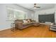 Spacious living room with hardwood floors, ceiling fan, a comfortable sofa, TV, and natural light at 941 Shirley Se St, Smyrna, GA 30082