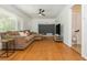 Spacious living room with hardwood floors, ceiling fan, large windows, comfortable sofa and TV at 941 Shirley Se St, Smyrna, GA 30082